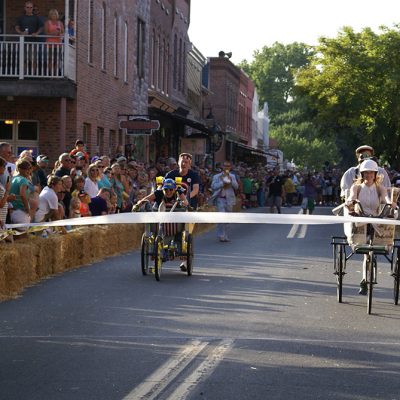 Two sets of racers on bike-like bathtub carts