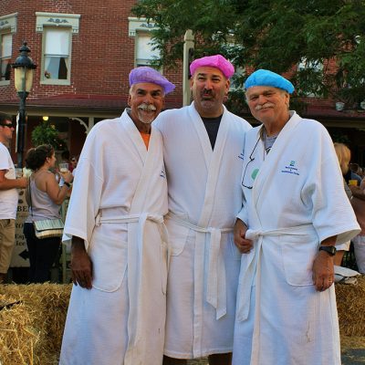 Three men in bathrobes and shower caps