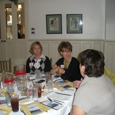 Women sitting at a table talking to each other