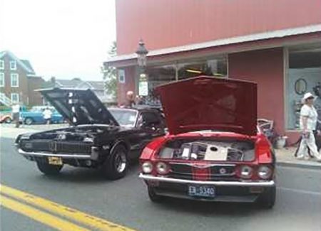 a couple of cars parked next to each other on a street