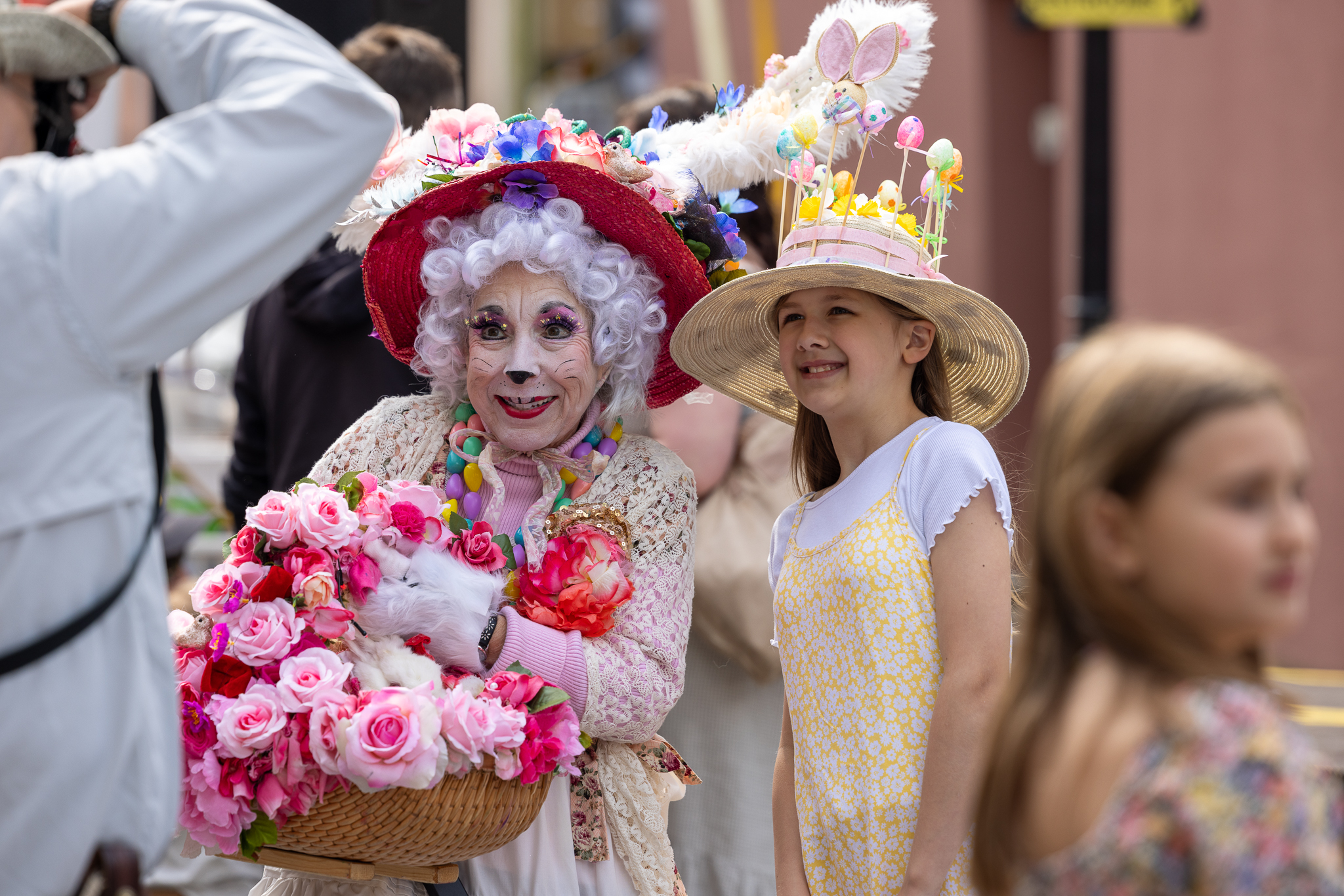 a woman in a clown costume holding a basket of flowers
