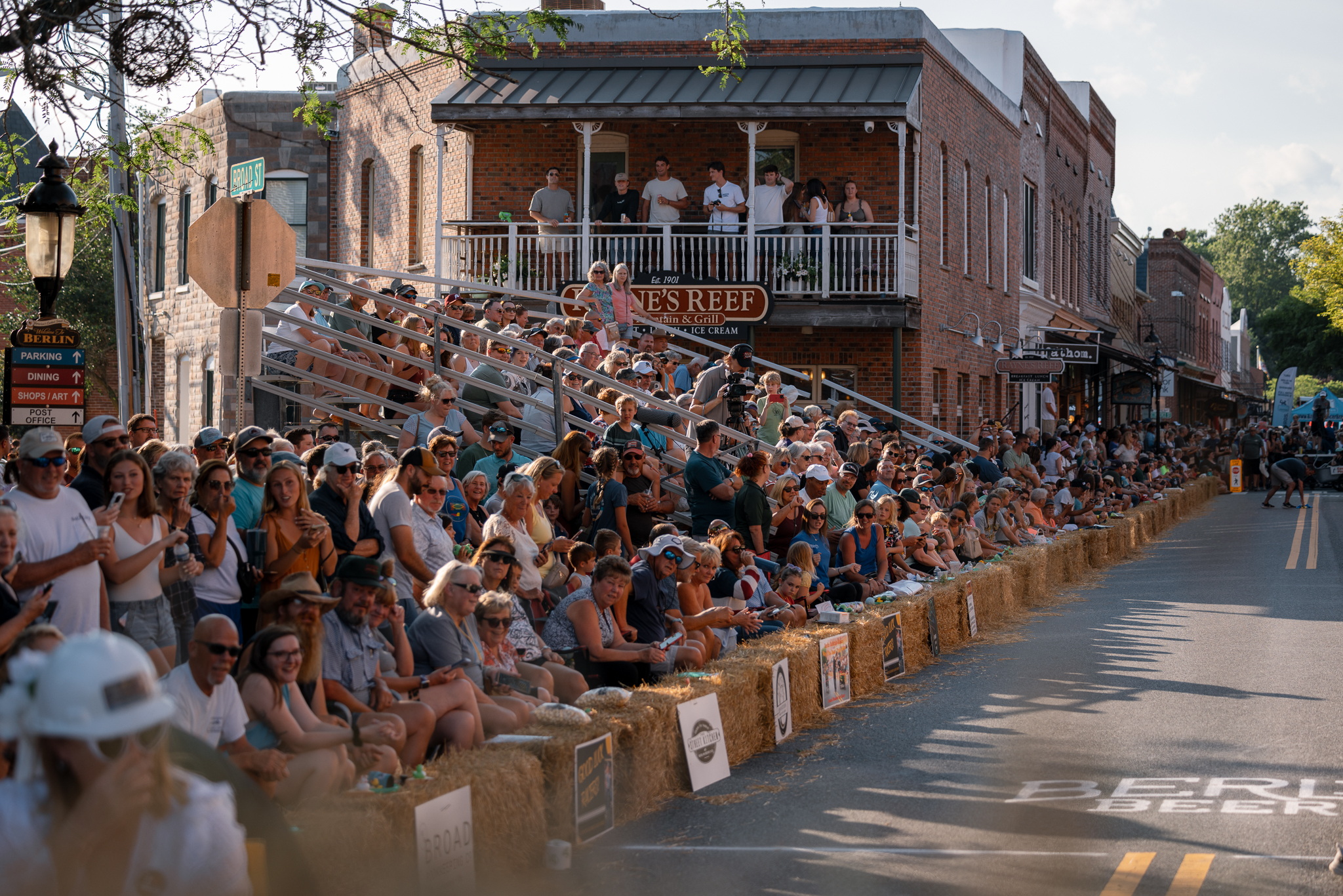 A crowd of people cheering on the Bathtub Races