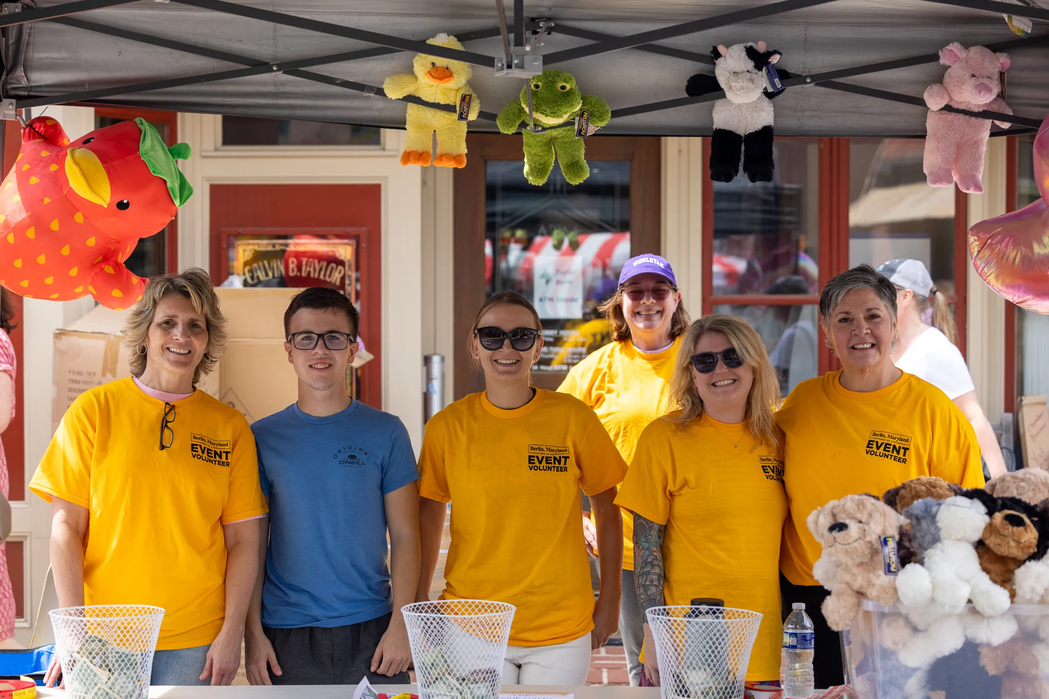 a group of people standing in front of a table